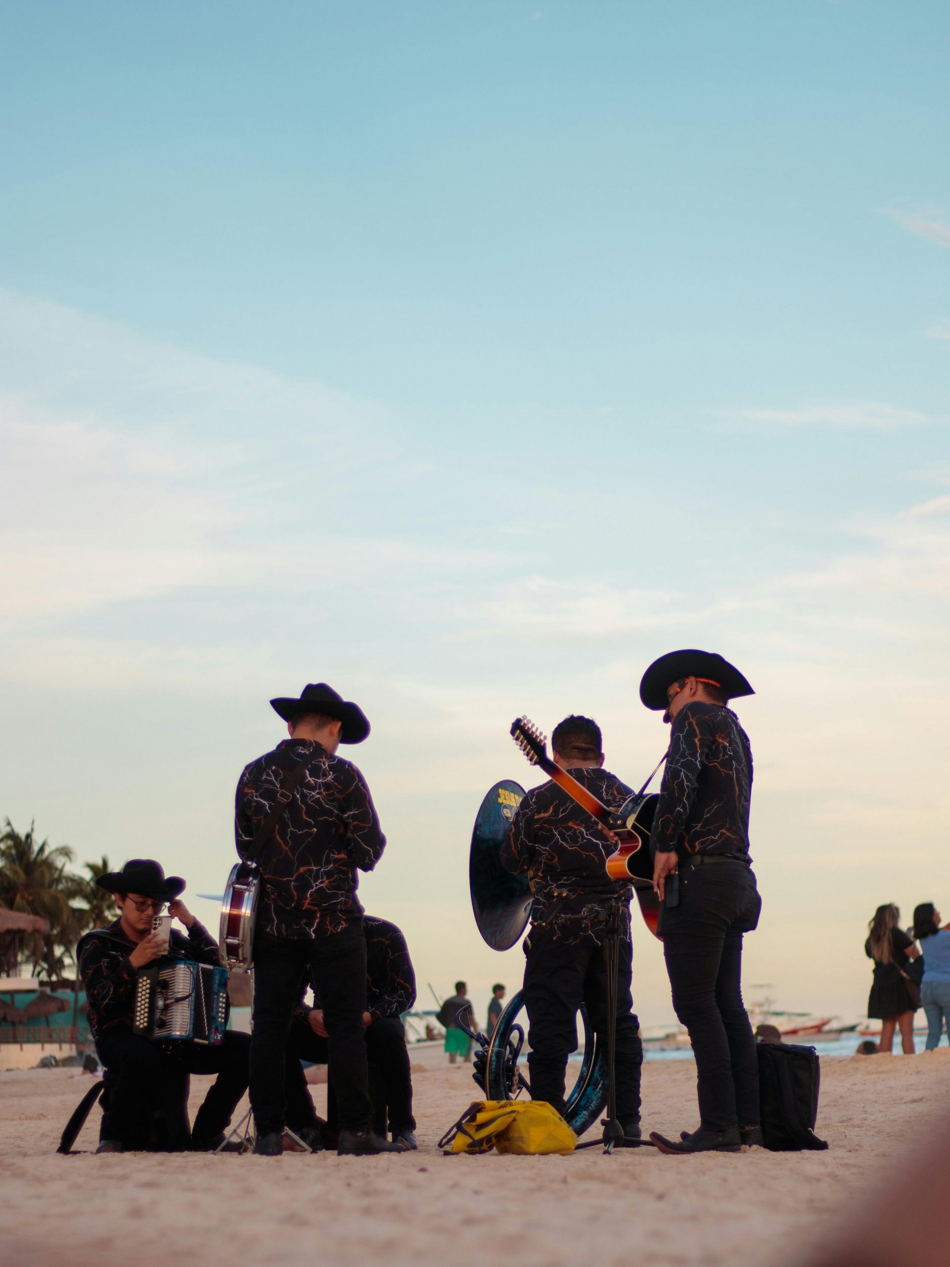 A Mexican band performing regional music on a sunny beach in Cancun.