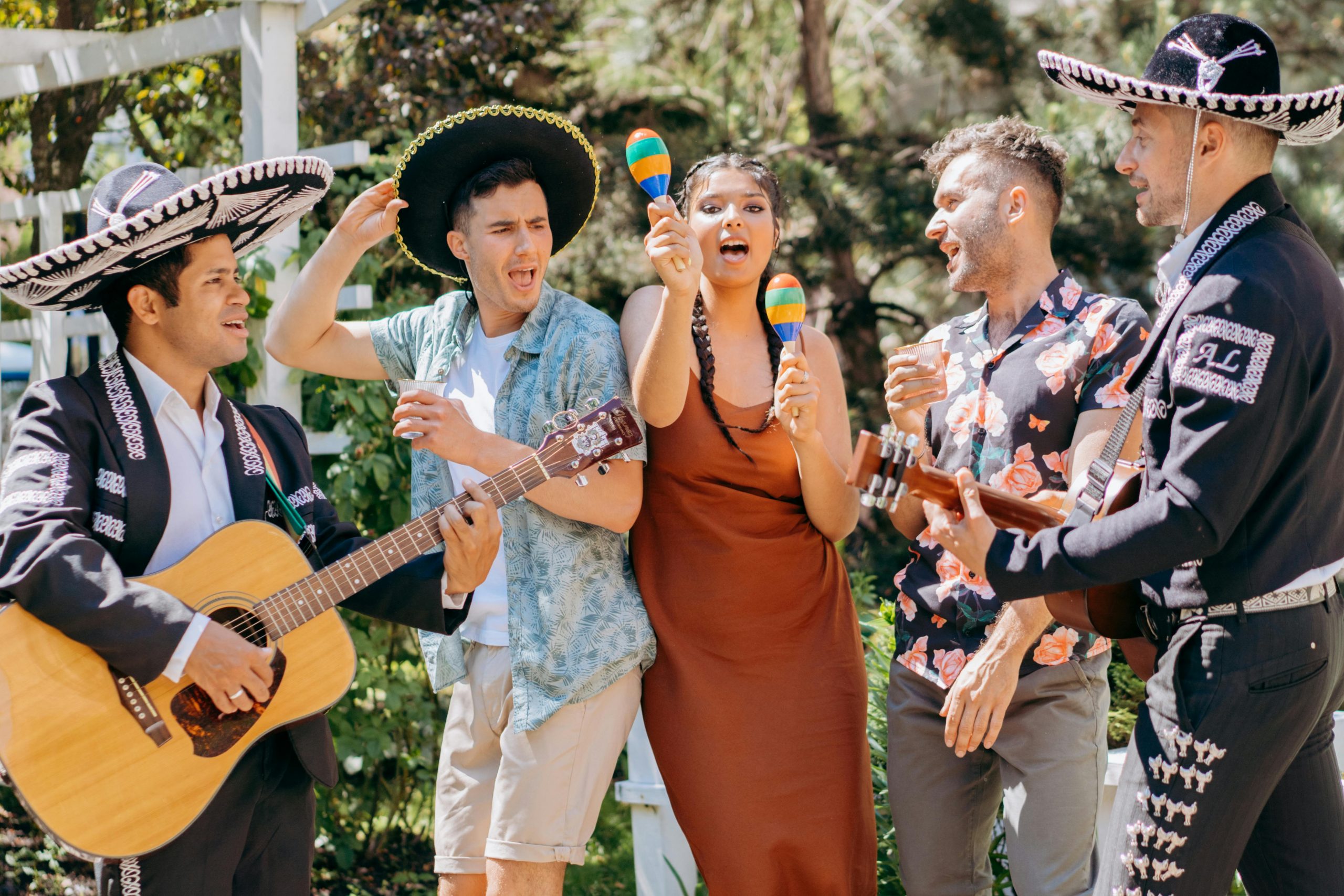 A lively outdoor mariachi band performing with guitars and maracas, embodying Mexican culture.