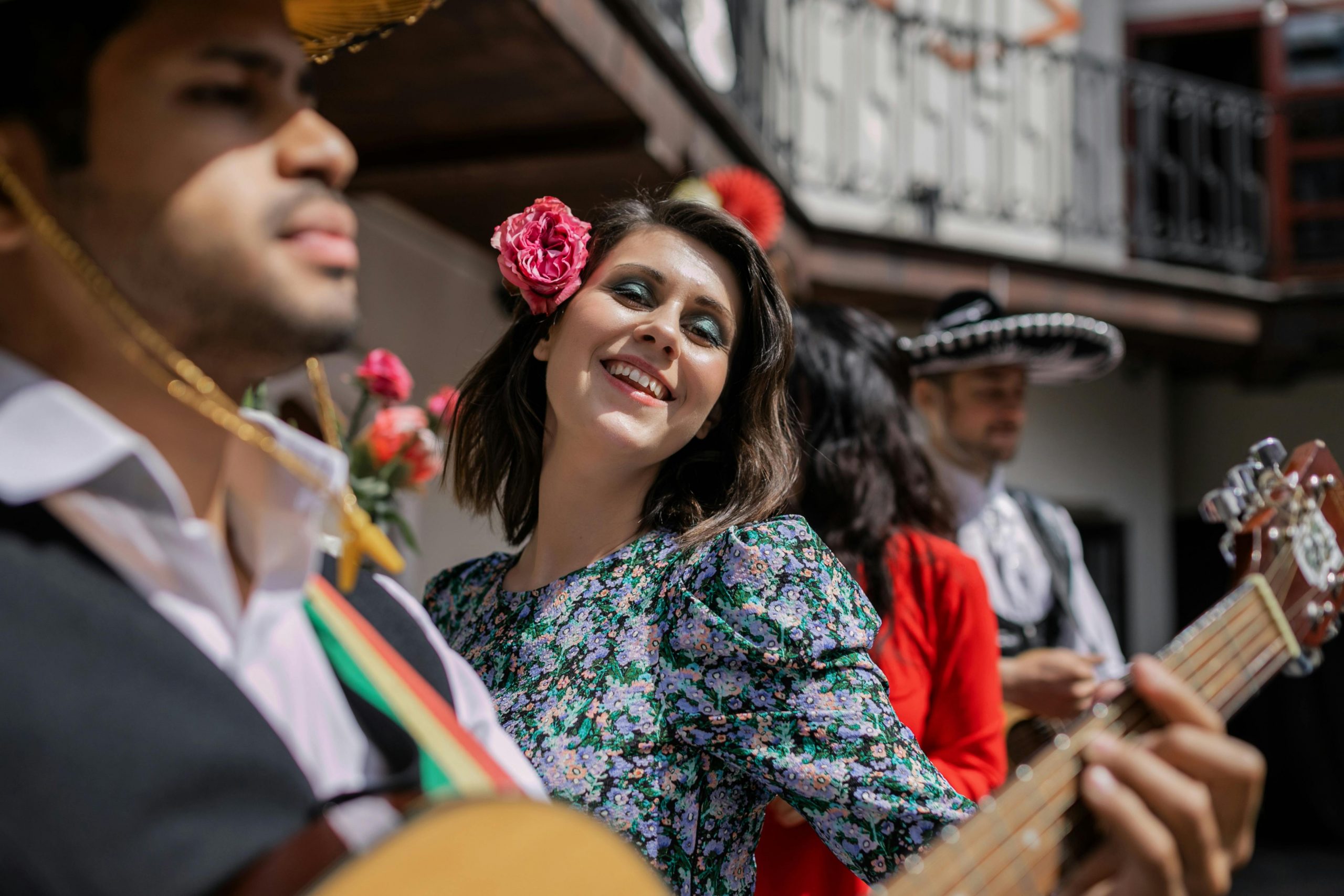 A vibrant outdoor celebration featuring musicians in traditional attire, showcasing joyful expressions.