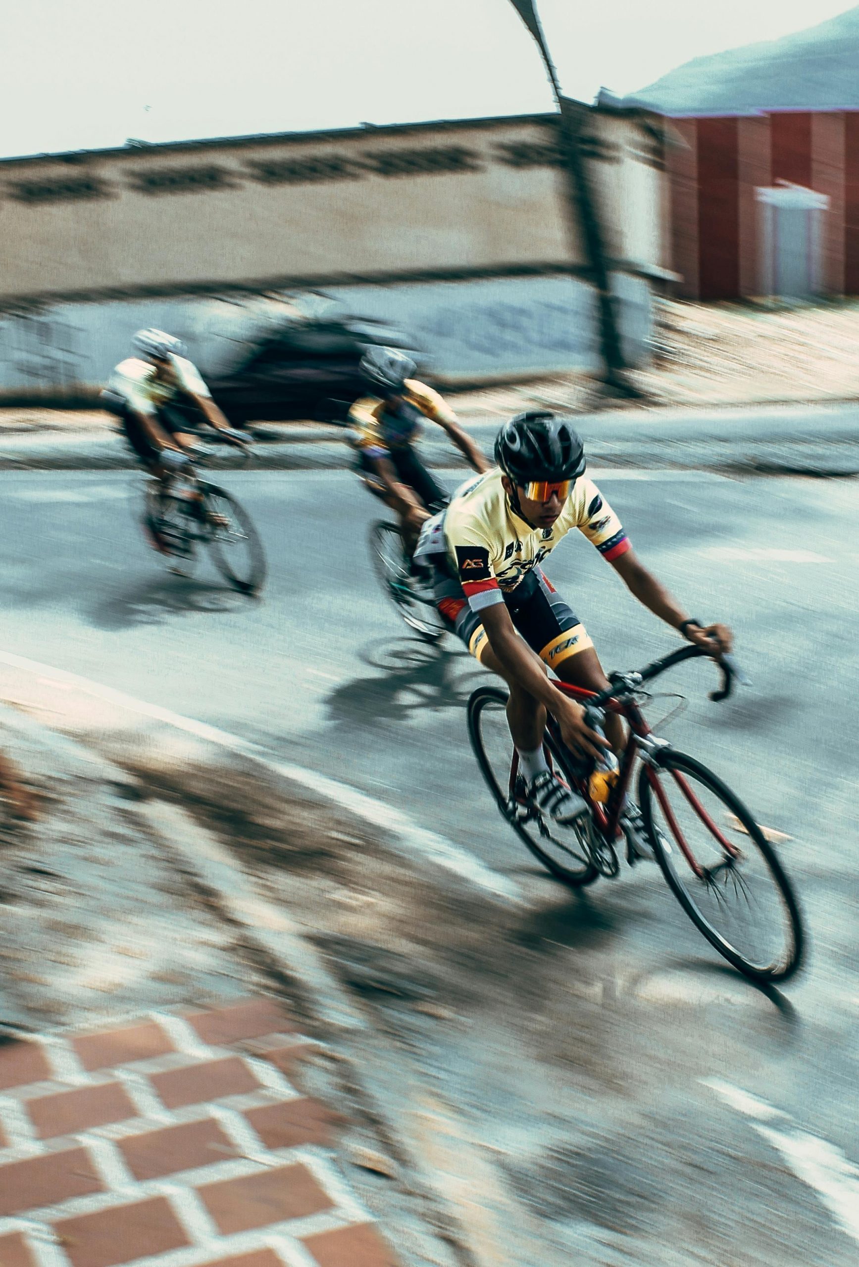 Intense bicycle race with athletes speeding through urban streets, showcasing agility and competition.