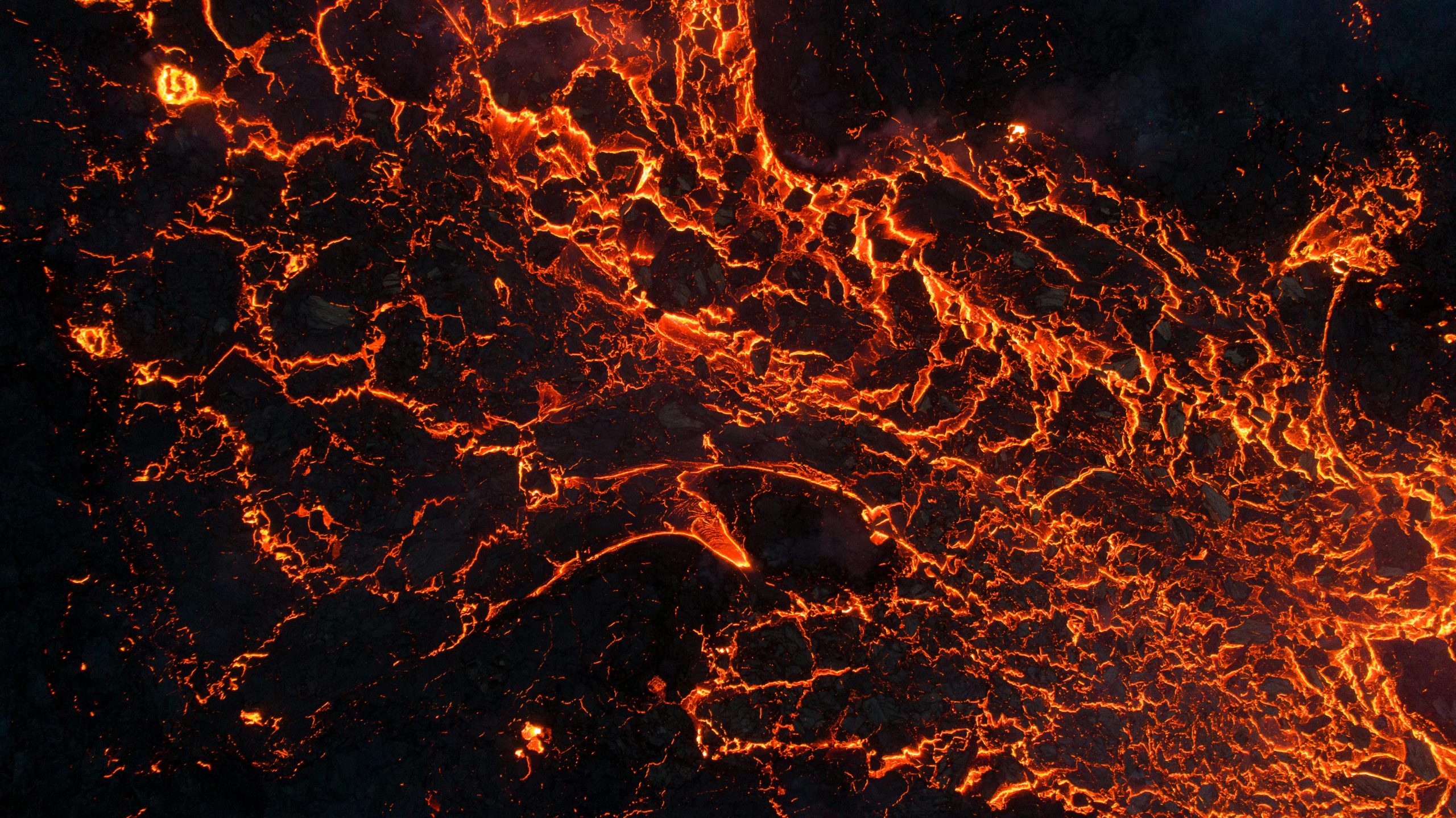 A captivating aerial shot of glowing lava showing natural volcanic activity.
