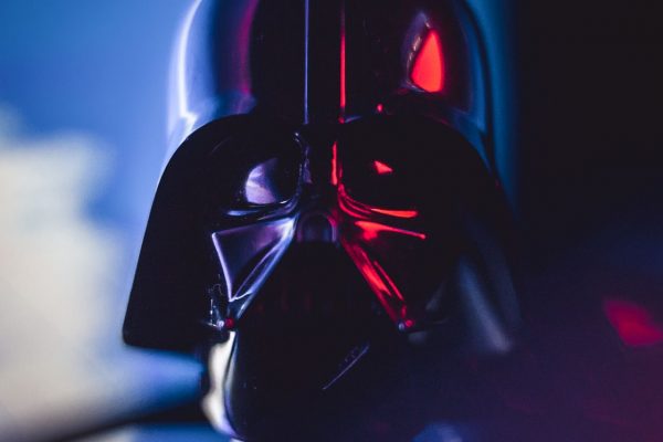 Close-up of a Darth Vader mask with striking lighting effects, showcasing cinematic appeal.