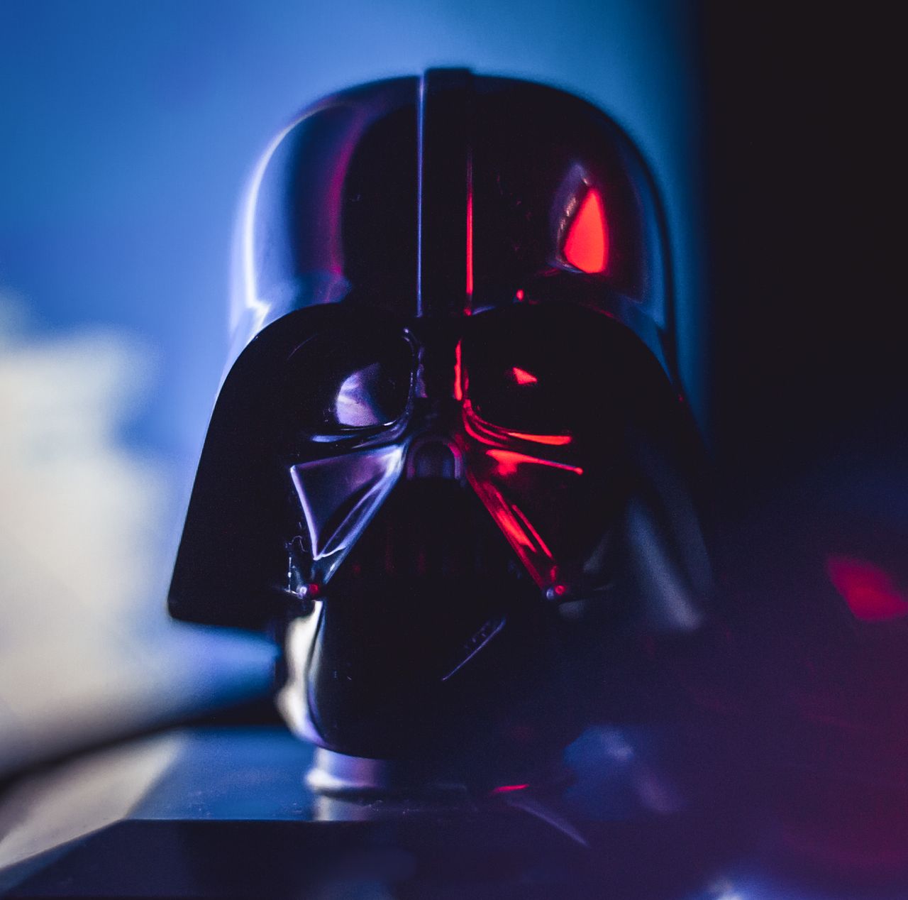 Close-up of a Darth Vader mask with striking lighting effects, showcasing cinematic appeal.